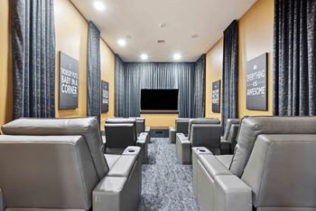 theater room at hideaway north scottsdale with large tv screen and couches